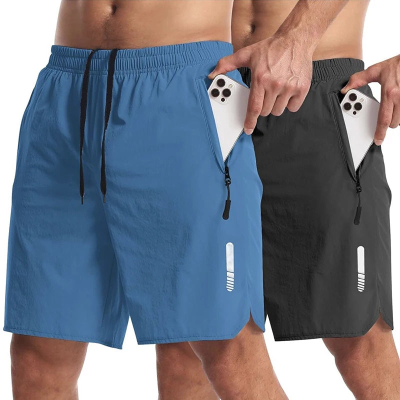 Two pairs of shorts, one blue and one black, with a phone in the pocket.